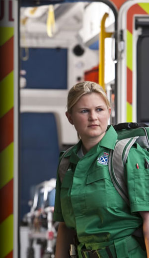 Paramedic standing outside an ambulance