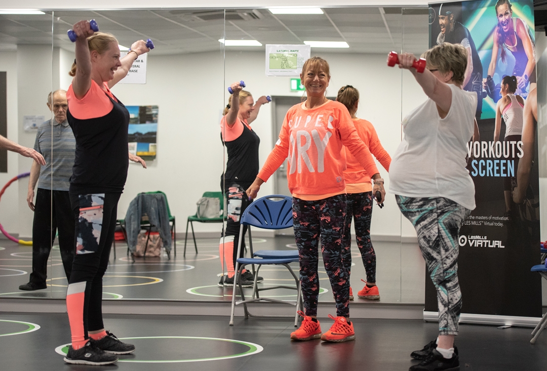 people holding weights in a Leisure Centre