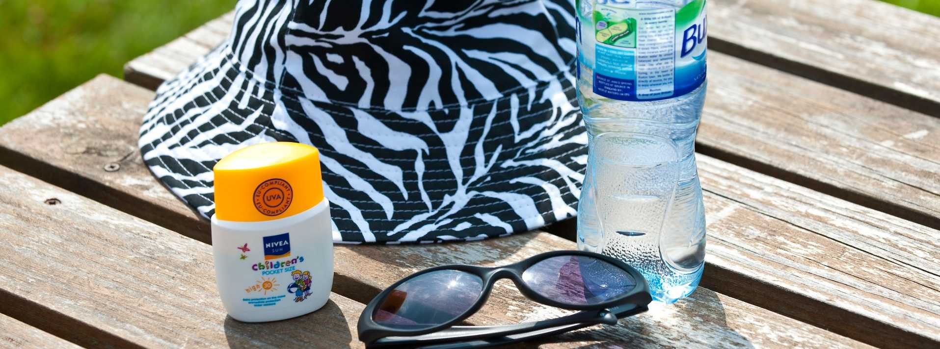 sunscreen items on a picnic table