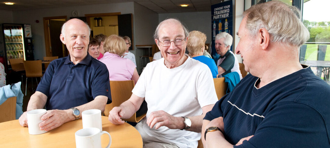 3 people sitting around a table drinking