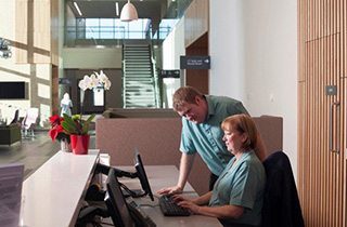 receptionists at desk inside Lanarkshire Beatson building