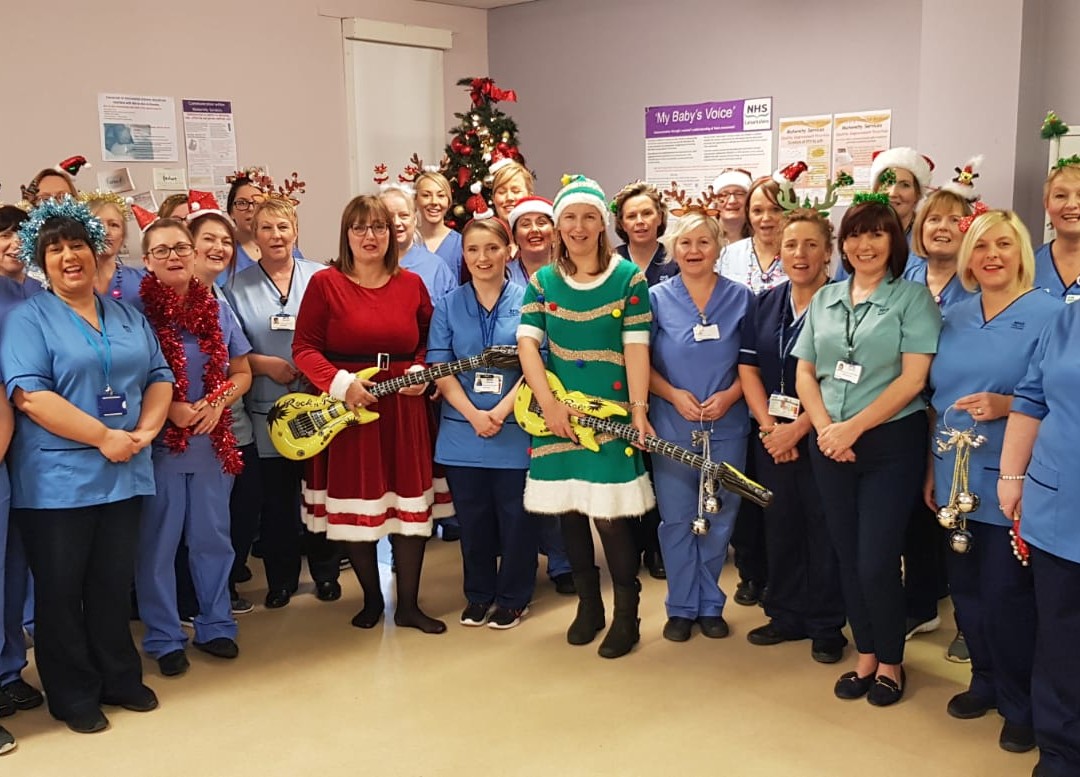 group of people singing and wearing festive outfits