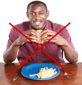 a person eating with a red cross over the top