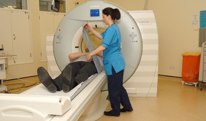 a radiographer talking to a patient