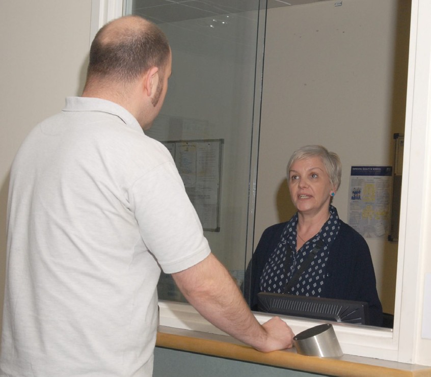 a person talking to reception staff