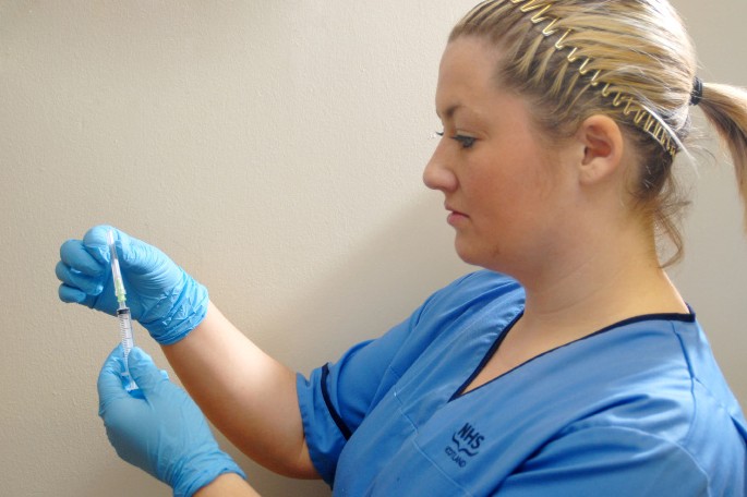 Nurse preparing a syringe 