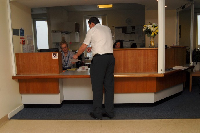 a man talking to a receptionist