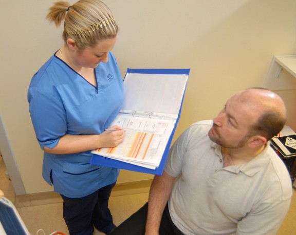 a nurse talking with a patient 