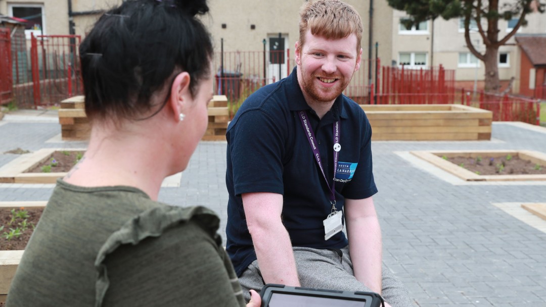 Resident completing survey with SLC staff member