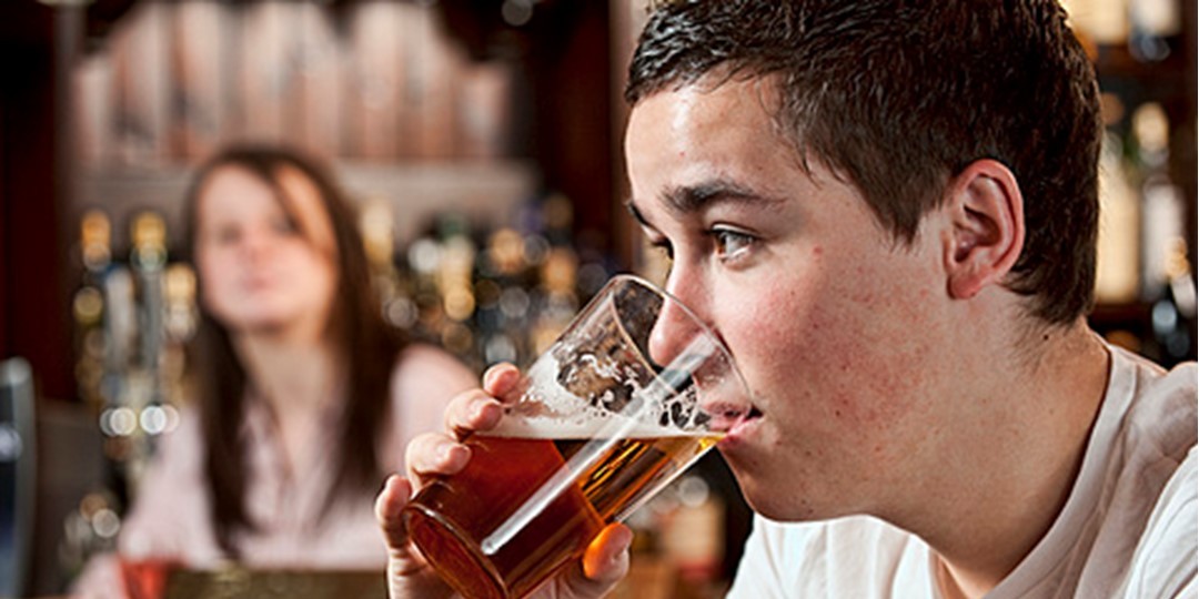 Image of young male drinking beer