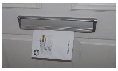 letter coming through a letterbox