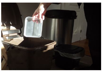 plastic tub being placed in bin