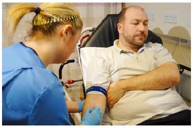 nurse taking blood from a patients arm