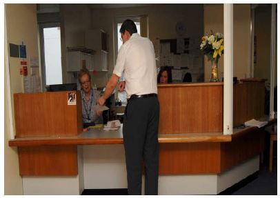 patient talking to a receptionist