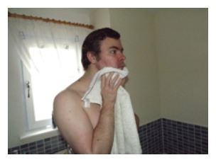 man towel drying his face