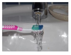 toothbrush under a tap
