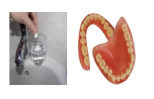 teeth being placed in glass of water