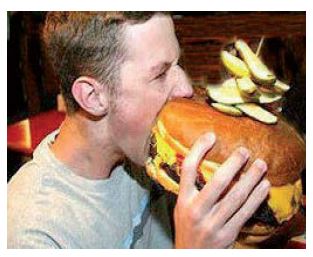 person eating a huge beef burger with two hands