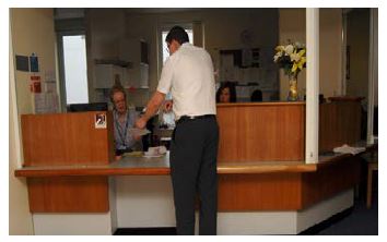 a patient at reception desk