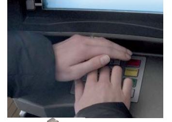 person entering their pin at an atm