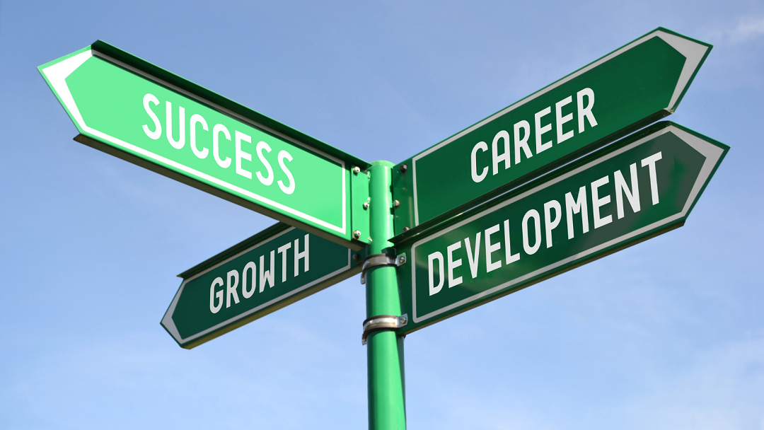 4 way signpost pointing to success, growth, career and development