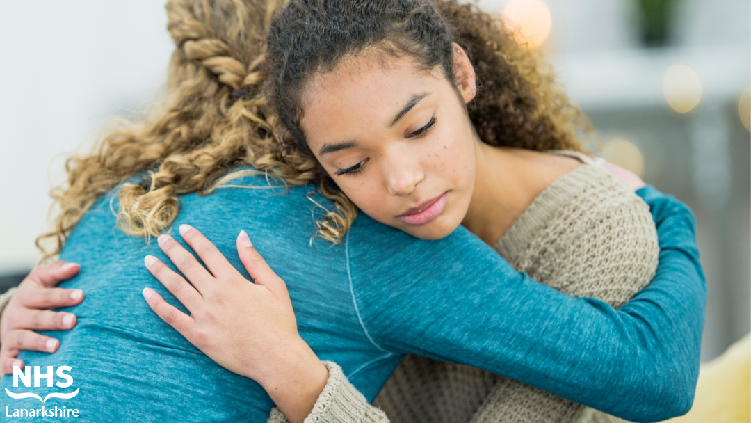 two women hug each other