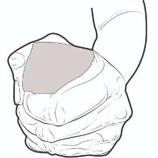 Fist squeezing a block as a hand therapy exercise