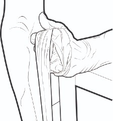 Stretching a theraband across a table at the joint of the elbow