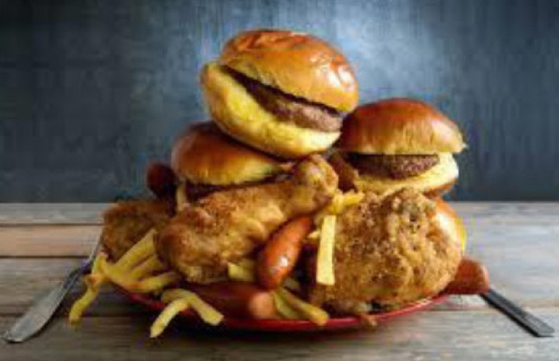 Plate with several burgers, fried chicken and chips
