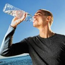 man drinking bottle of water