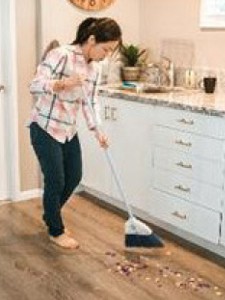 Person sweeping the floor