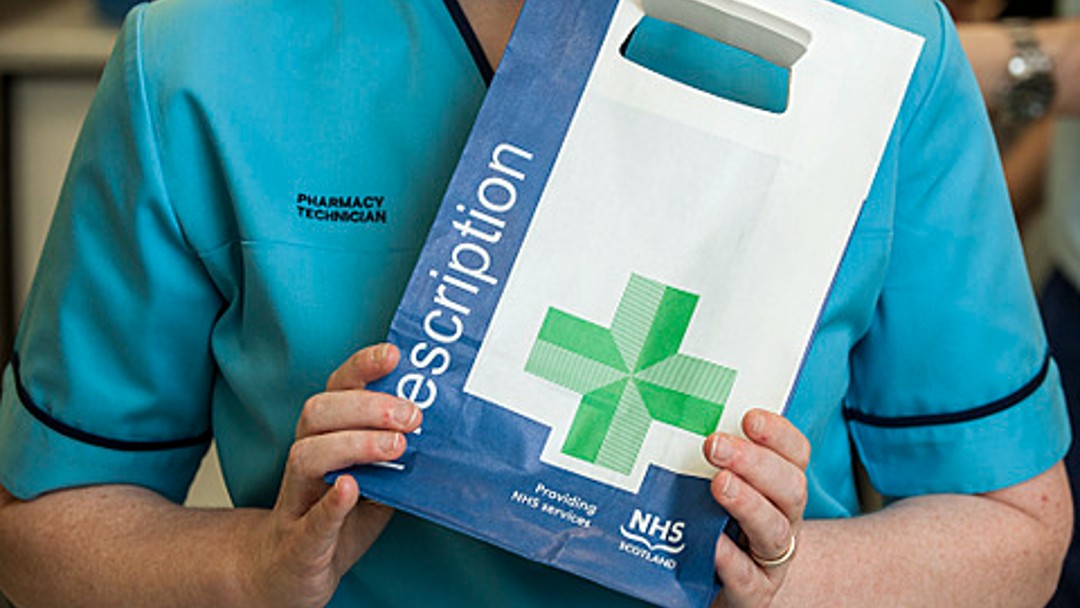 Image of pharmacist holding prescription