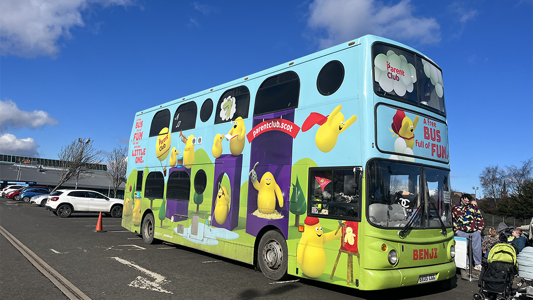 Play Talk Read bus; Benji parked with a blue sky above.