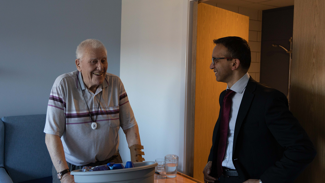 two men chat smiling