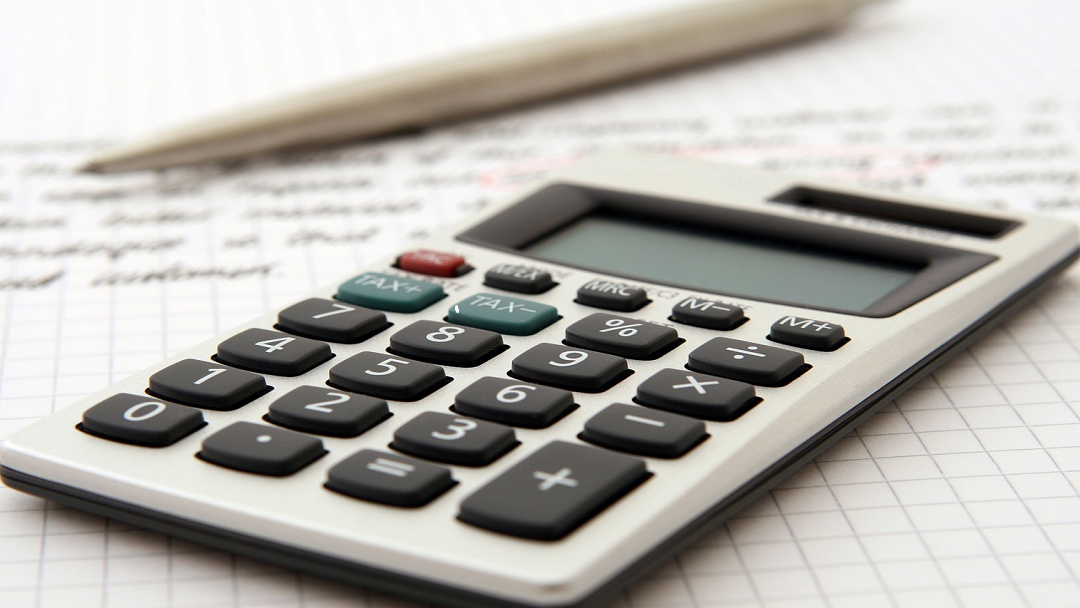 calculator, pen and hand written text