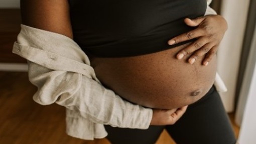 pregnant woman touching her stomach