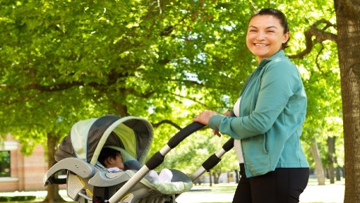 Woman walking with her newborn in pram