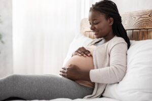 Pregnant woman lying down relaxing. 