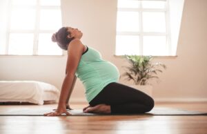 Pregnant woman taking part in yoga. 
