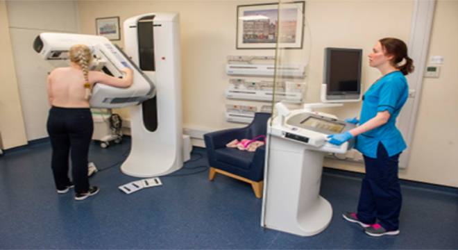 a woman having a mammogram