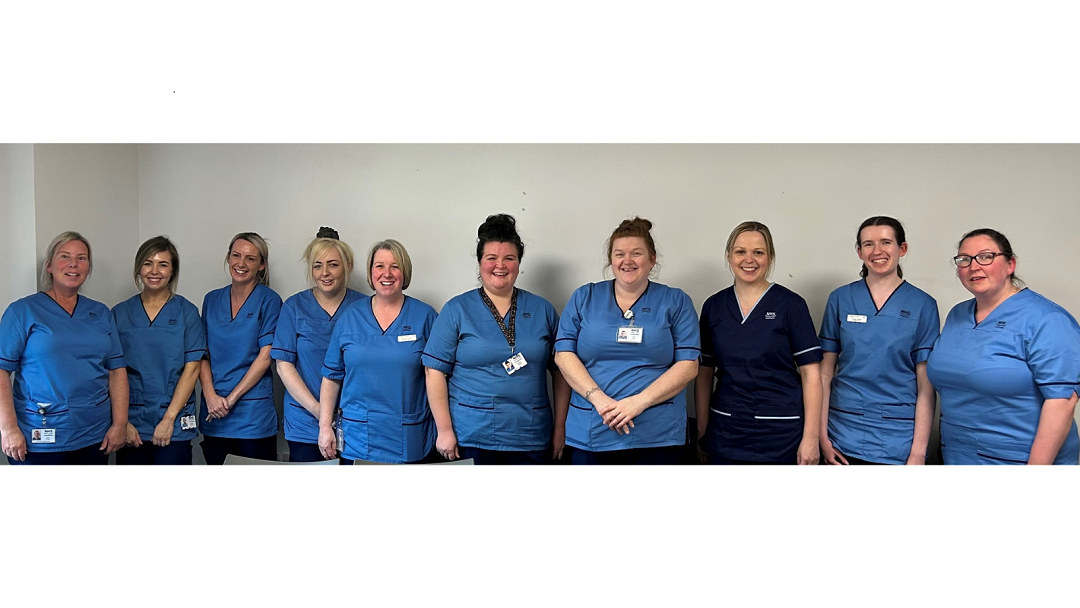 10 uniformed female nurses smile at the camera