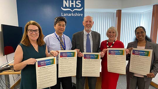 Holding the pledge that goes with the new anti-racism plan (from left): NHS Lanarkshire Chief Executive Louise Long; NHS Lanarkshire Anti-Racism Champion Colin Lee; NHS Lanarkshire Board Chair Martin Hill; Jacqui Jones, NHS Lanarkshire Deputy Chief Executive and Director of Human Resources; Professor S Josephine Pravinkumar, NHS Lanarkshire Director of Public Health and Health Policy
