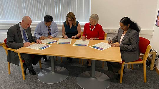 Signing the pledge that goes with the new anti-racism plan (from left): NHS Lanarkshire Board Chair Martin Hill; NHS Lanarkshire Anti-Racism Champion Colin Lee; NHS Lanarkshire Chief Executive Louise Long; Jacqui Jones, NHS Lanarkshire Deputy Chief Executive and Director of Human Resources; Professor S Josephine Pravinkumar, NHS Lanarkshire Director of Public Health and Health Policy
