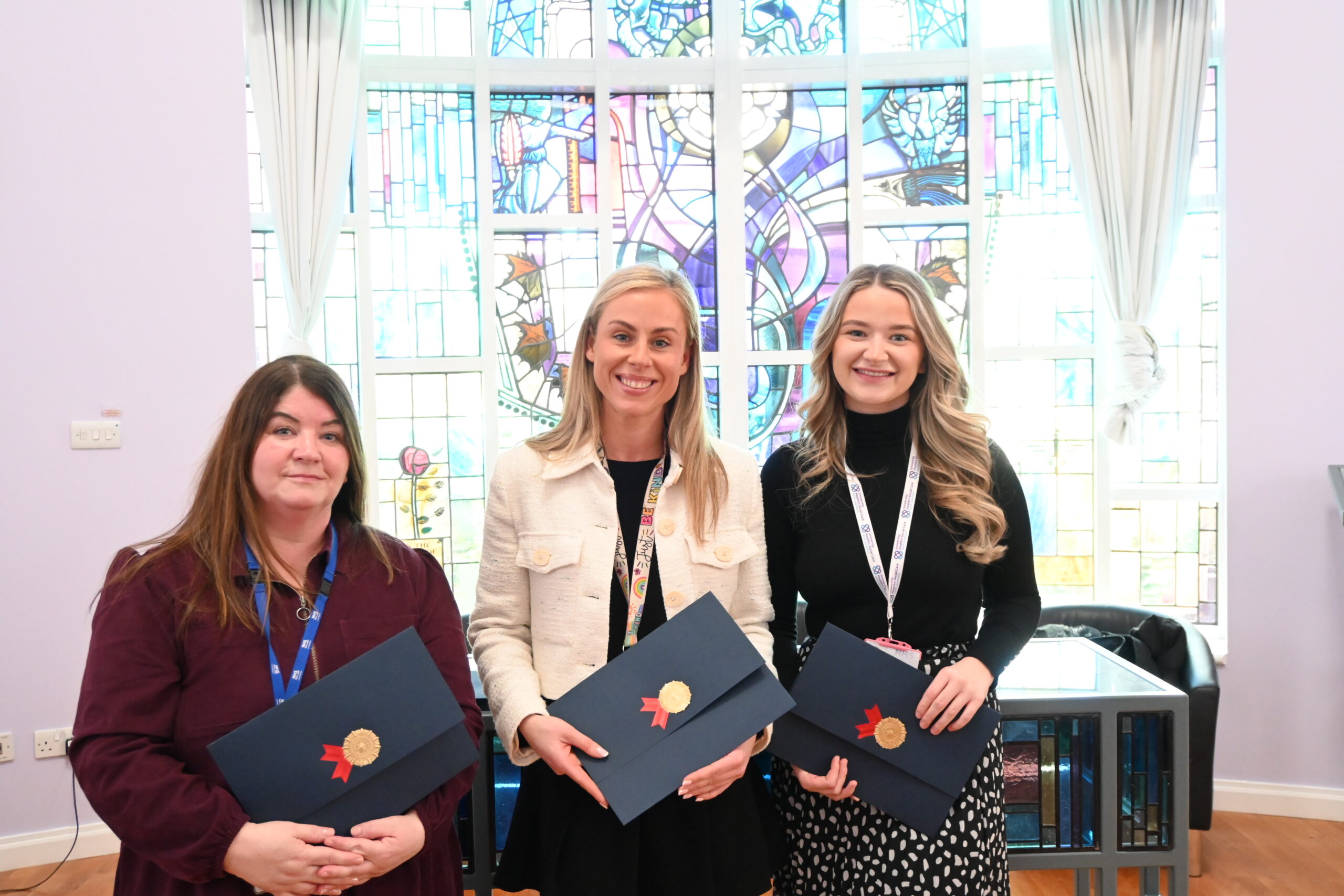 Three graduates of UHSCNL ceremony marking their successes.