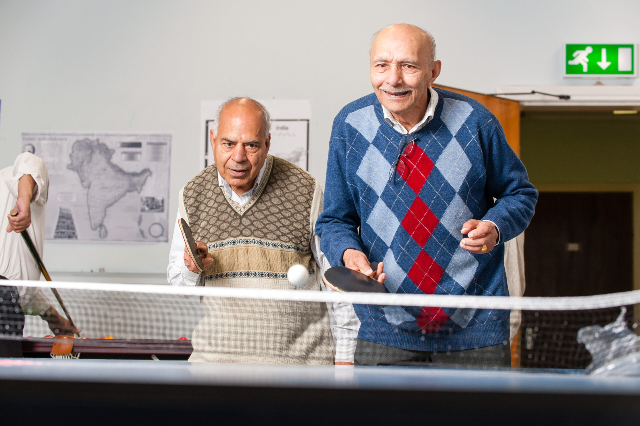 Two older men playing table tennis as an example of the success of the Frailty Strategy