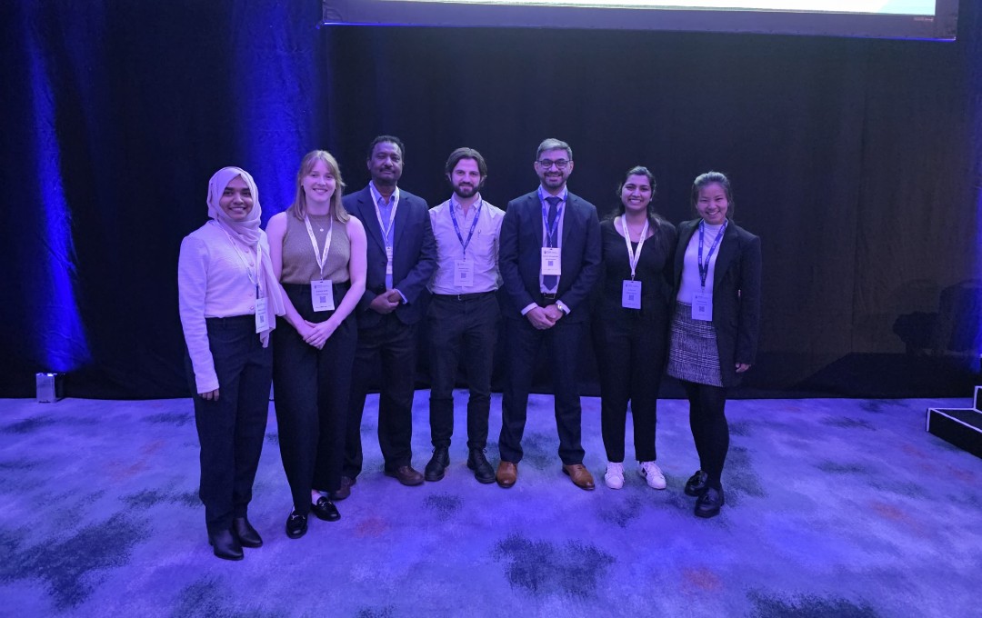 Photograph of Mr Khurram Khan, consultant upper gastrointestinal surgeon at UHH with surgical trainees at the Association of Surgeons of Great Britain and Ireland International Surgical Congress 2026