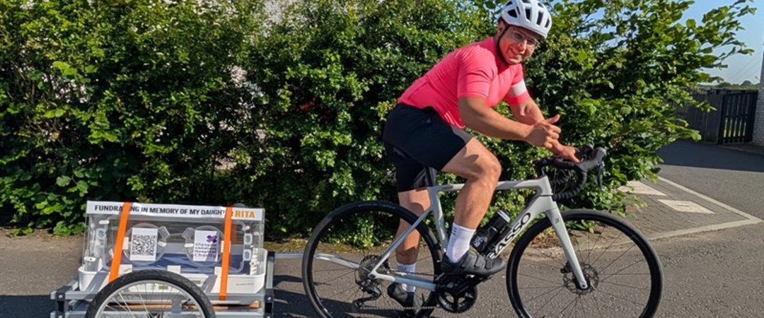 Fadi on bike pulling incubator 1080